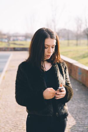 young beautiful woman using smartphone in the cityの写真素材