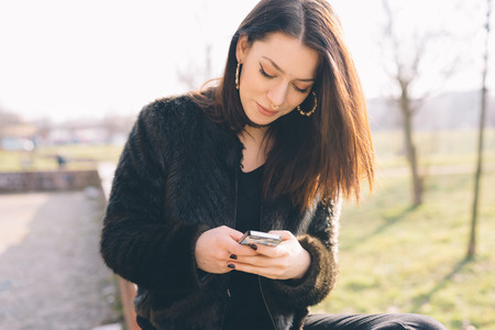 young beautiful woman using smartphone in the cityの写真素材
