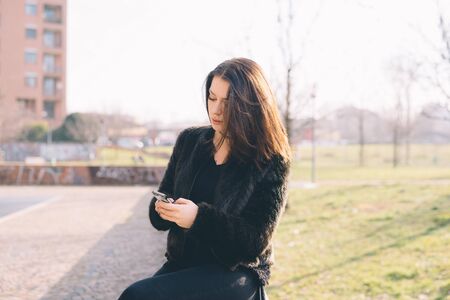 young beautiful woman using smartphone in the cityの写真素材