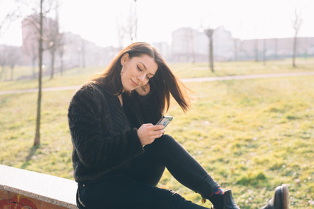 young beautiful woman using smartphone in the cityの写真素材