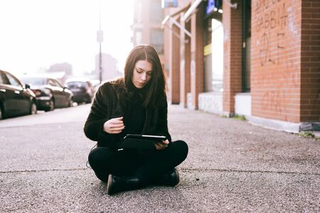 young beautiful woman using tablet in the cityの写真素材