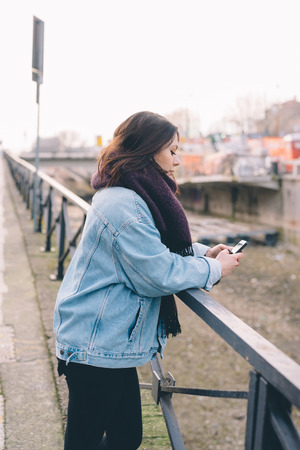 young beautiful woman using smartphone in the cityの写真素材