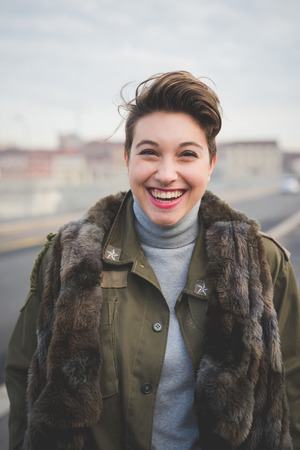 young beautiful short hair hipster woman in townの写真素材