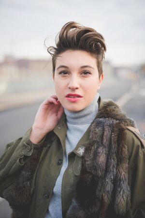 young beautiful short hair hipster woman in townの写真素材