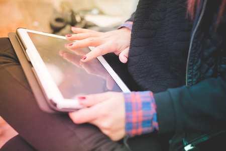 close up of hands woman using technological device tablet connected wirelessの写真素材
