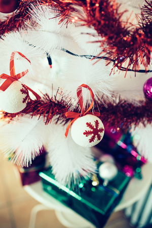 Close up on a tree decoration, a white ball with red snowflakes pictured on it - christmas, holiday, decoration conceptの写真素材