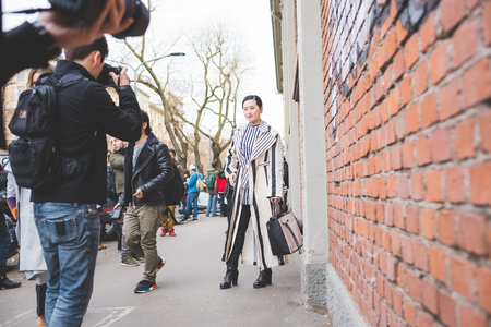 Milan, Italy - February 25, 2016: people attending models and vips in the streets during Milan Fashion Week Women Fall/Winter 2015/2016のeditorial素材