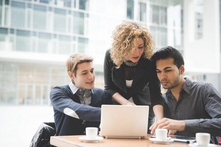 Multiracial business people working connected with technological devices like tablet and notebook - teamwork, business, working conceptの写真素材