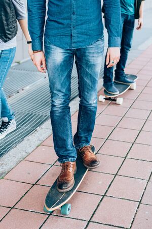 From the neck down view of young man riding skateboard - skater, sportive conceptの写真素材