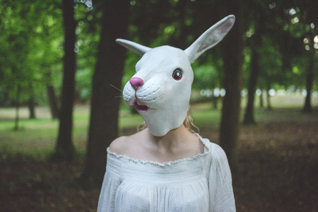 Portrait of young woman wearing rabbit mask -  carnival, halloween, surreal conceptの写真素材