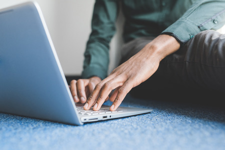 Close up on the hand on a businessman typing on the keyboard of a modern notebookの写真素材