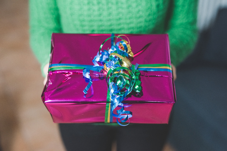 Close up on a gift wrapped with colorful ribbonの写真素材