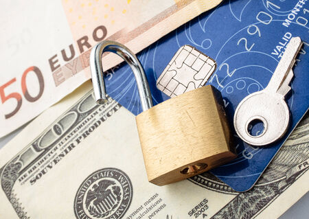 Credit card with chip, money, padlock and key.