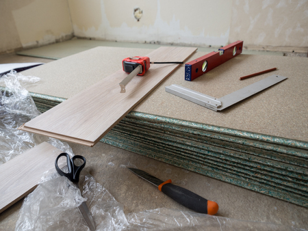 Repairing apartment's  floor . Plates of pressed wood chips. Laminate. Measuring the Tools, building...