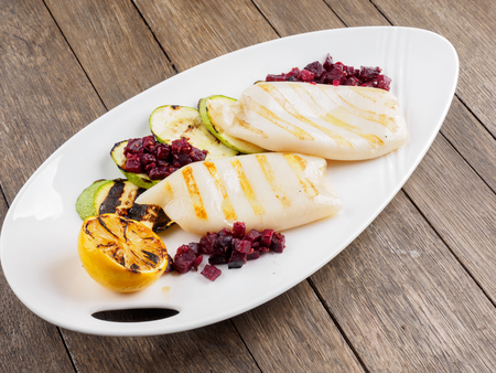 Restaurant dish.Grilled squids and vegetables.の写真素材