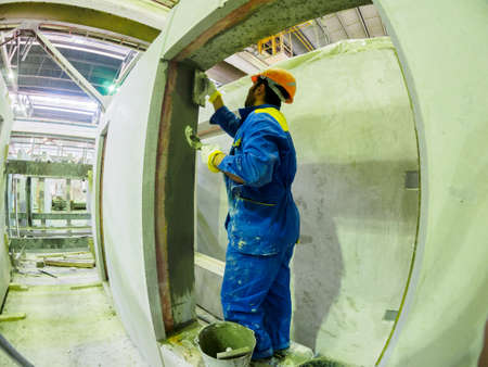 Gatchina, Russia - July 23 2019. 
Workers in the workshop of the  House-building plant Gatchinsky...