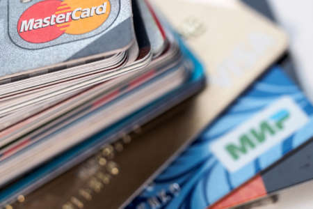 Saint Petersburg, Russia - February 3 2020. 
A pack of plastic bank cards of various payment systems.のeditorial素材