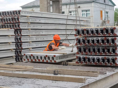 Gatchina, Russia - July 23 2019. 
Workers in the workshop of the  House-building plant "Gatchinsky SSK", producing panels for construction and reinforced concrete structures.のeditorial素材
