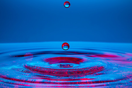 Water splash isolated on blue background.の写真素材