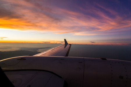 airplane over the ocean during sunsetの写真素材