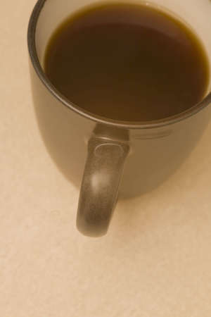 Hot coffee in a cup with steam rising from the cupの写真素材