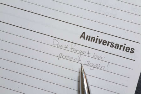 Calender reminder page with memo to not forget anniversary presentの写真素材