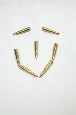 Smiley face made of AK-47 rounds to illustrating a contrast between violence or war and happinessの写真素材