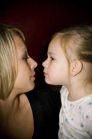 Mother and daughter getting ready to kissの写真素材