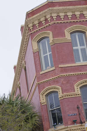 Building with corner window and gold trim. Arhcitecture is circa 19th century. Located in a coastal Florida townの写真素材
