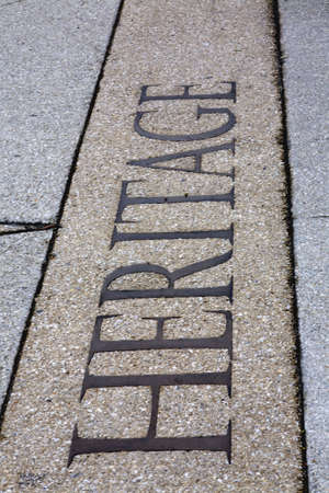 The word heritage inscribed into a pebble sidewalkの写真素材