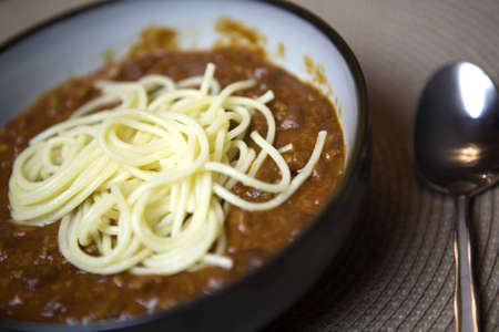 Winter is the season for hot meals such as this steaming bowl of chili topped with fresh spaghetti の写真素材