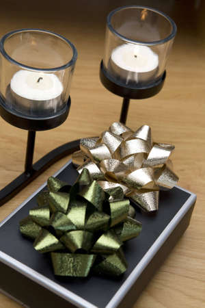 Romantic gift giving. Present next to two small tea candles.の写真素材