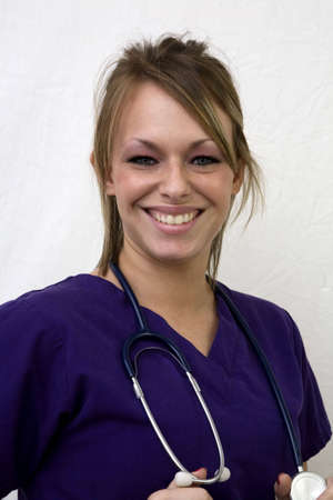 Smiling female medical professional in scrubs with stethoscope.の写真素材