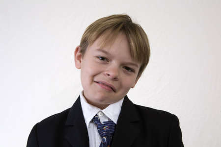 Boy in a suit with an obviously fake sad frown expression. の写真素材