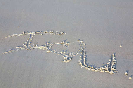 I love you written in the sand with a romantic heart symbol.の写真素材