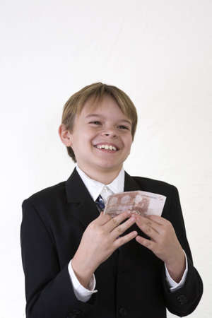 A young man holds a 10 euro note with a huge smile of happiness on his face.の写真素材