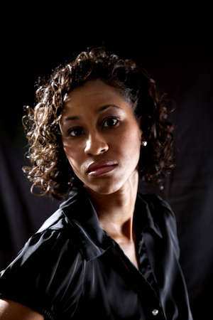 Backlit shot of black female model against black backgroundの写真素材