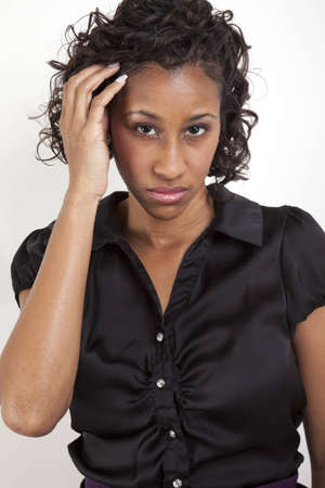 African American woman with a high fashion look as she brushes her hair asideの写真素材