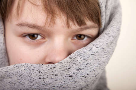Close up of a young boy wearing a tribal headdressの写真素材