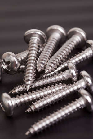 Pile of silver colored construction screwsの写真素材