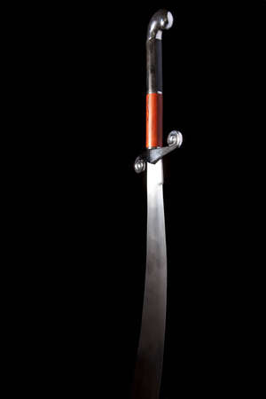 Dramatically lit persian scimitar fading into a black backgroundの写真素材