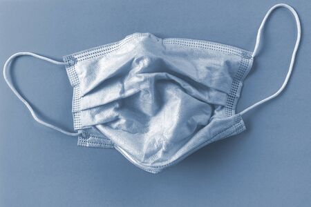 Protective mask on blue background. Disposable surgical face mask cover mouth and nose. Healthcare medical Coronavirus quarantine, hygiene concept. Prevent coronavirusの写真素材