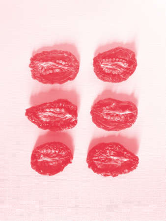 Sundried or dried tomato halves, top view, different shapes and sizes, seeds up.
