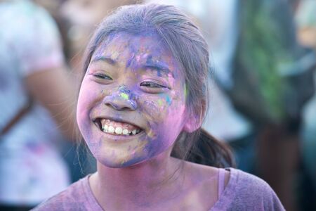 Young oriental woman covered with color powder while celebrating the Holi Festival in Naplesのeditorial素材