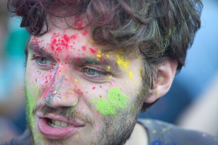 Naples, Italy, September 12 2015: Holi Festival of colors. A participant covered with color powder.のeditorial素材