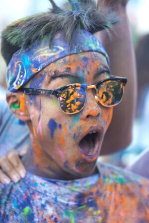 Naples, Italy, September 12 2015: Holi Festival of colors. A participant covered with color powder.のeditorial素材