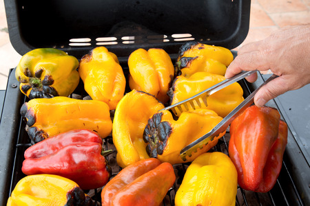 Raosting peppers on the barbecueの写真素材