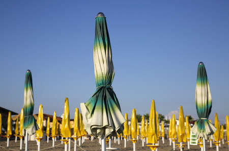 Colorful closed parasols on Mediterranean beachの写真素材