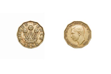 Old three pence coin isolated on whiteの写真素材