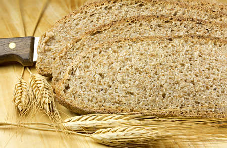 Slices of wholemeal bread  on wooden background